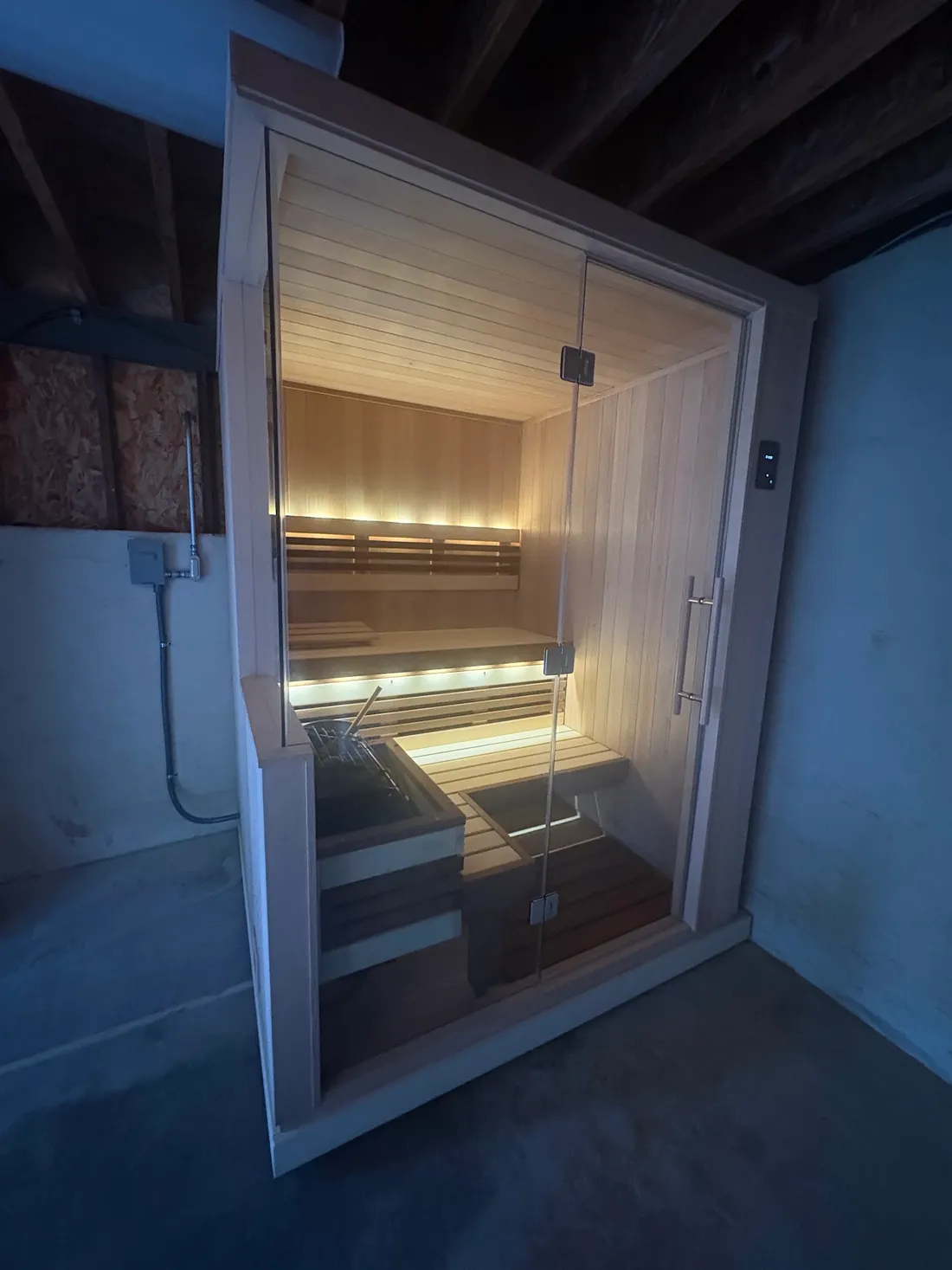 A glass sauna room with lights along the benches, Mill Valley