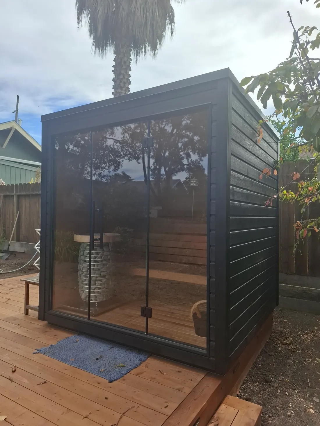 The black outdoor cabin seen from the garden, Oakland