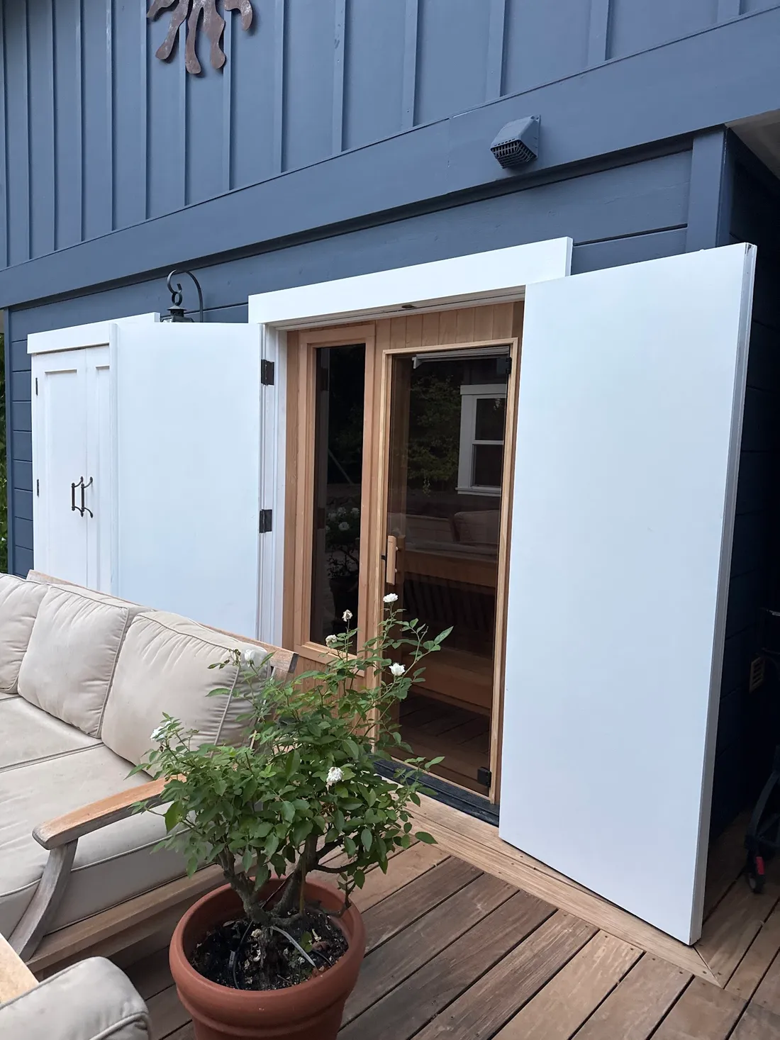 A sauna built into an outdoor storage closet, its doors open onto a patio