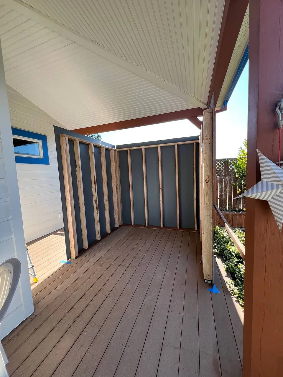 The frame of an outdoor sauna going up on a deck