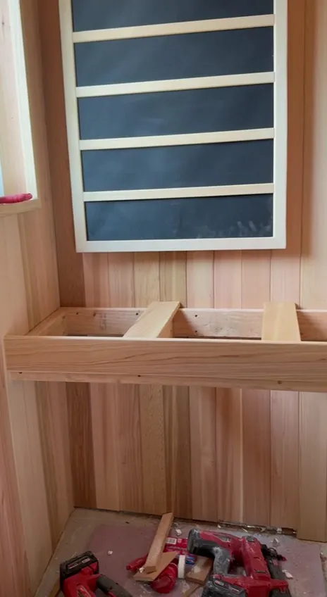 Bench framing under an infrared panel before the slats go on